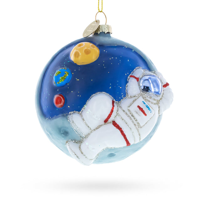 Astronaut Floating in Outer Space Glass Christmas Ornament